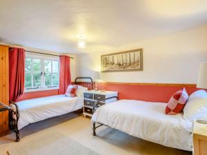 a bedroom with two beds and a window at 3 Bed in Aldborough 85528 in Thurgarton