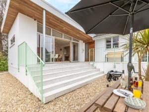 a home with a large patio with an umbrella at 3 Bed in Braunton 86042 in Braunton
