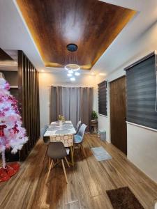 a dining room with a table and a christmas tree at 4 bedrooms Newly Build Vacation House in Bacolod