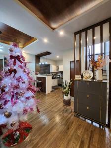a living room with a christmas tree in a house at 4 bedrooms Newly Build Vacation House in Bacolod
