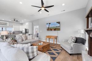 a living room with two couches and a ceiling fan at 061 Bay Breezes on Port Royal in Dauphin Island