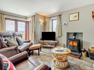 a living room with a couch and a fire place at 3 Bed in Aberdovey DY032 in Aberdyfi