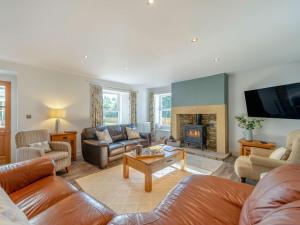 a living room with a couch and a fireplace at 4 Bed in Hexham 87458 in Catton