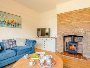 a living room with a blue couch and a fireplace at 3 bed in Whitstable 88750 in Whitstable