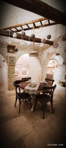 アルベロベッロにあるトゥルッロ デル ベスコボのテーブル、椅子、ソファが備わる客室です。