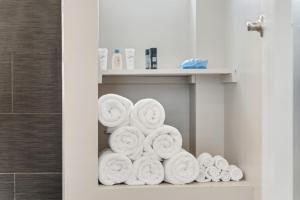 a pile of towels on a shelf in a bathroom at Spacious Hideaway minutes from Downtown with Parking in Chicago