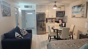 a living room and kitchen with a table and chairs at Beach Front Condo Paradise. Ground Floor.Studio. in Longboat Key