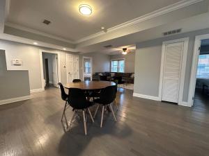 an empty living room with a wooden table and chairs at Spacious Wicker Park Hideaway with Parking! in Chicago