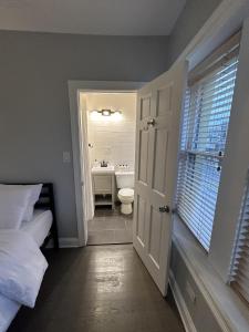 a bathroom with a bed and a toilet and a sink at Spacious Wicker Park Hideaway with Parking! in Chicago