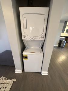 a white tv sitting on top of a floor at Spacious Wicker Park Hideaway with Parking! in Chicago