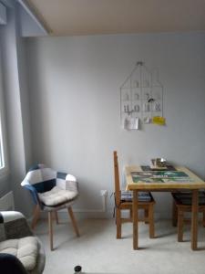 a dining room with a table and a chair at Studio des Thermes 2* in Vittel