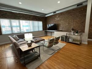 a living room with a couch and a tv at Trendy Wicker Park Loft with Parking in Chicago
