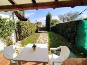 a white table and chairs on a patio at Villetta a schiera Bilocale cod. 354 - Taunus Vacanze in Sirolo