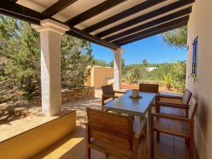 a patio with a table and chairs on a porch at Can Miguel Marti - Astbury Formentera in Playa Migjorn