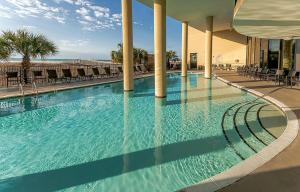 a large swimming pool in a building with chairs at 314 Holiday Isle 314 in Dauphin Island