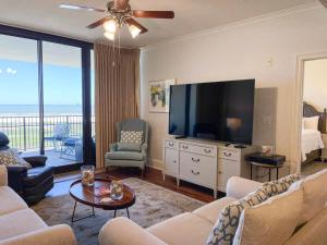 a living room with a large television and a living room at 507 Holiday Isle 507 in Dauphin Island