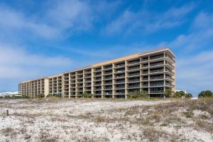 a large building on the beach next to a field at 507 Holiday Isle 507 in Dauphin Island