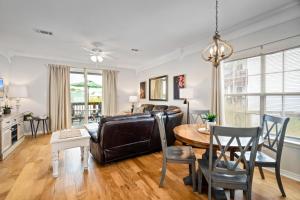 a living room with a table and a couch at 019 Sandcastle 4D in Dauphin Island