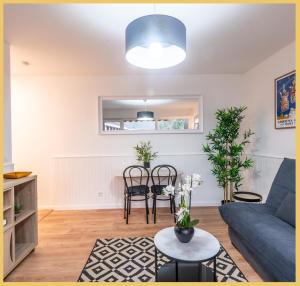 a living room with a blue couch and a table at Studio / Mountain / Cluses in Cluses