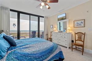 a bedroom with a bed and a view of the ocean at 320 Holiday Isle in Dauphin Island +13 photos