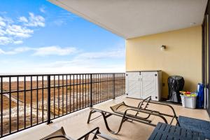 a balcony with chairs and a view of the ocean at 511 Holiday Isle 511 in Dauphin Island