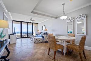 a living room with a table and chairs at 520 Holiday Isle 520 in Dauphin Island