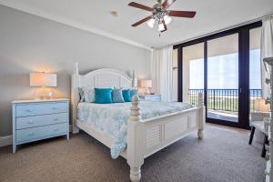 a white bedroom with a bed and a window at 520 Holiday Isle 520 in Dauphin Island +19 photos