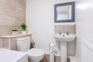 a bathroom with a toilet and a sink and a mirror at Centralised Admiralty Terrace with FREE PARKING by Prescott Apartments in Bristol