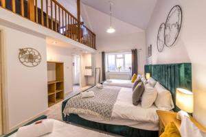 a large bedroom with two beds and a staircase at Centralised Admiralty Terrace with FREE PARKING by Prescott Apartments in Bristol