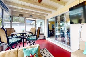 a screened in porch with a table and chairs at Relax in Retro in Clearwater
