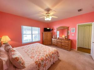 a bedroom with red walls and a bed and a window at 039 Two Views in Dauphin Island