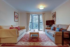 a living room with two couches and a table at The Foundry in Oxford