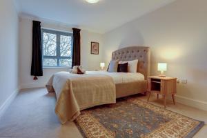 a bedroom with a large bed and a window at The Foundry in Oxford