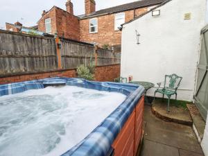 a hot tub in the backyard of a house at Castle Cottage in Lincoln