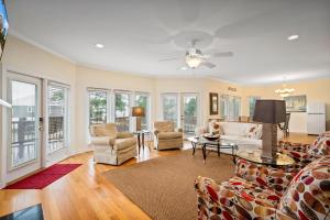 a living room with a couch and chairs at 025 The Sanderling in Dauphin Island