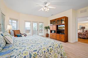 a bedroom with a bed and a ceiling fan at 025 The Sanderling in Dauphin Island