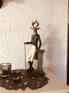 a figurine of a deer sitting on a column at Apartment Rosi SECONDO in Reisbach
