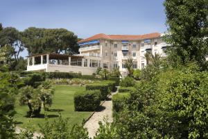 a large building with trees in the middle of it at Grand Hôtel Les Lecques in Saint-Cyr-sur-Mer