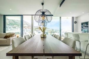 a dining room with a wooden table and a chandelier at 96-brand new apartment, Fuengirola in Fuengirola