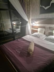 a stuffed animal is sitting on a bed at Шале Золота пiдкова та рiчка in Slavske