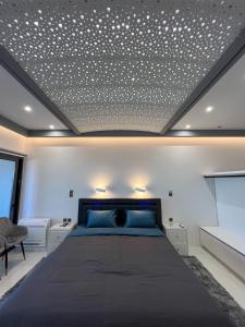 a bedroom with a bed and a ceiling with stars at Seafront Luxury Suite with Jacuzzi & Sauna in Monemvasia