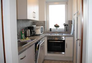 a kitchen with a sink and a stove top oven at Fewo Nordseestraße 5 in Büsum