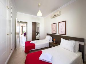 a hotel room with two beds and a red blanket at Casa Maddy - A charming location with every comfort in Playa Blanca +34 photos