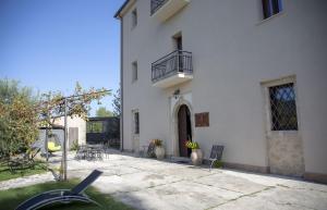 a white building with a balcony and a patio at Casino del Monaco in Casalvieri