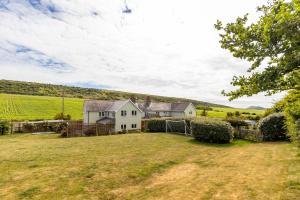 an image of a house with a yard at Poachers Lodge in Yarmouth