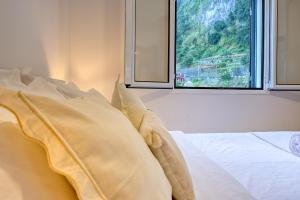 a bedroom with a bed and a window with a view at Casa Familia Pestana 2, a Home in Madeira in Seixal