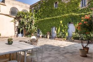 a patio with tables and chairs in front of a building at Masseria Costanza, Vendicari Retreat in Noto