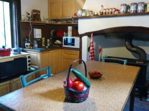 a kitchen with a table with a basket of vegetables on it at Guest House Pepeliana in Sŭbotkovtsi