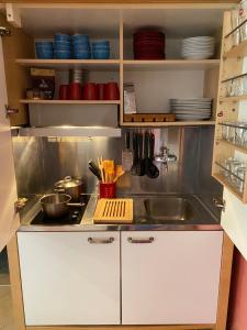 a kitchen with a sink and a counter top at Amazigh Guincho Hostel & Suites in Cascais