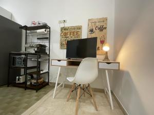 a computer desk with a white chair in a room at Casa Sofia Trastevere in Rome